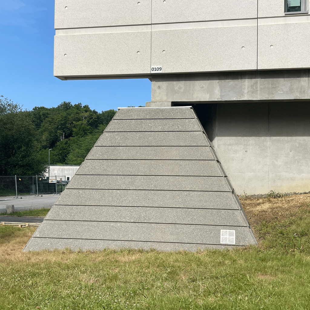 Pilier de soubassement en béton du Mess de Bayonne après application du traitement de pulvérisation traditionnel anti-mousse.